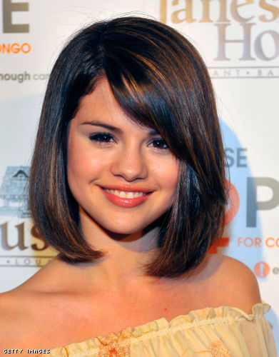 Selena Gomez is wearing a medium bob hairstyle that features a deep side